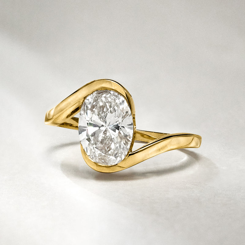 Asymmetrical yellow gold ring with oval lab-grown diamond center