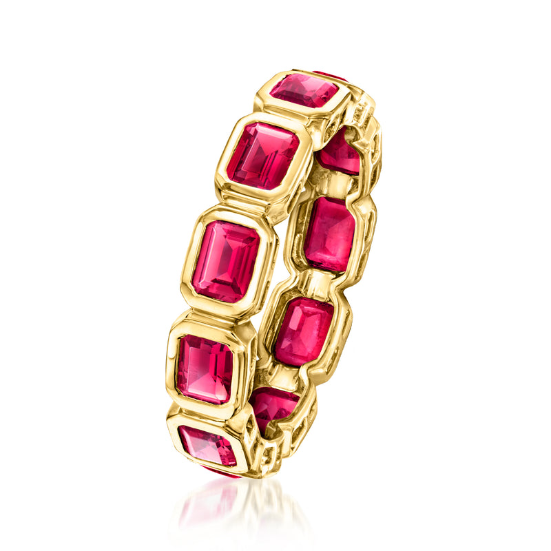 Gold side view eternity band with five square pink ruby gemstones