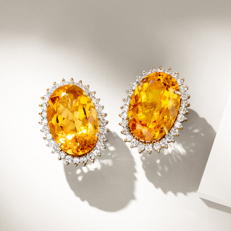 Pair of oval citrine earrings with diamond halo and yellow gold setting