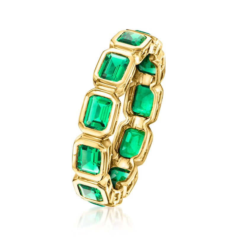 Gold over sterling eternity band with emerald-cut green stones, side view