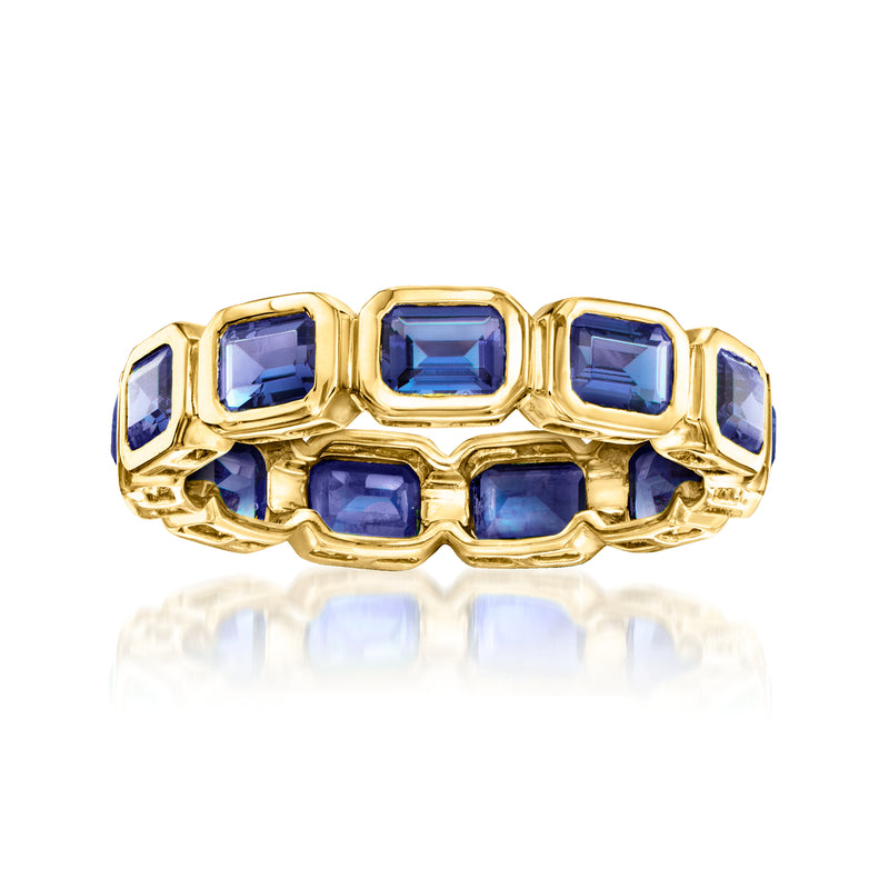 Gold eternity band with blue lab-grown sapphire square stones in prong settings