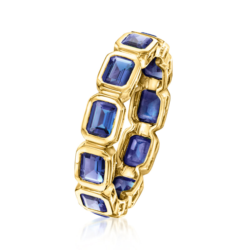 Gold eternity ring with blue sapphire square stones, side view with prong settings