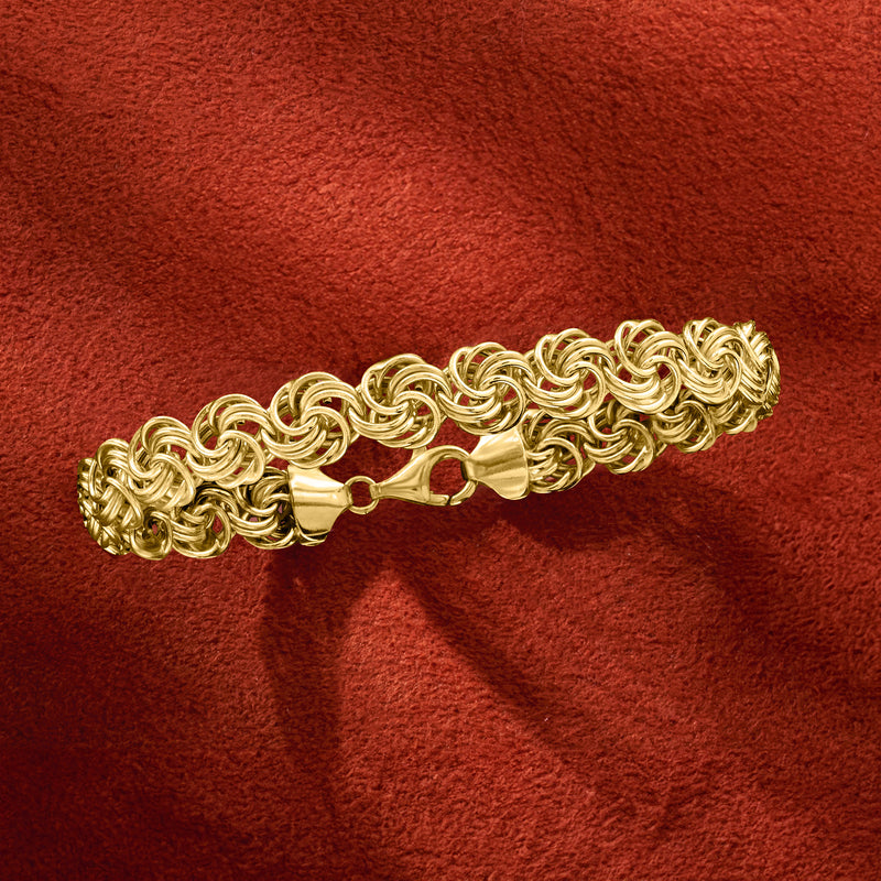 Gold rosette-link bracelet with heart clasp at the center of the chain