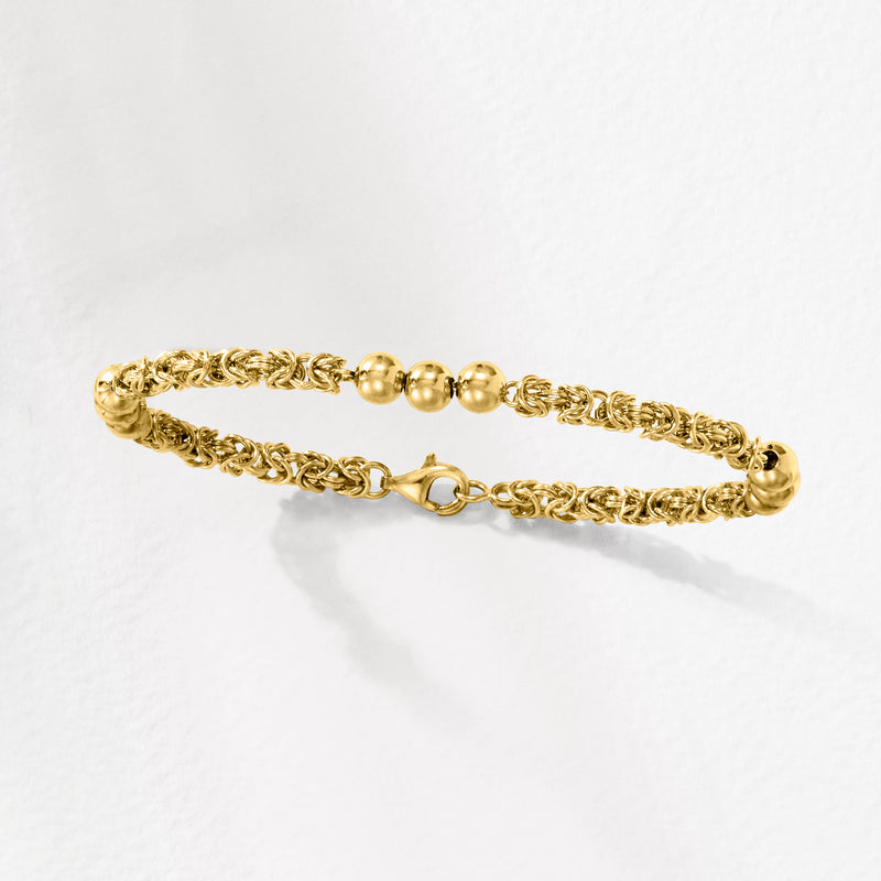 Gold-tone Byzantine link bracelet with round bead station and lobster clasp at end