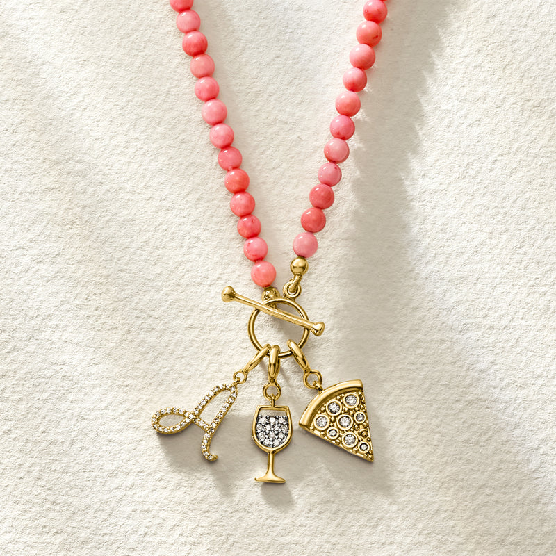 Pink coral bead toggle necklace with gold-tone charms: anchor, wine glass, and pizza slice