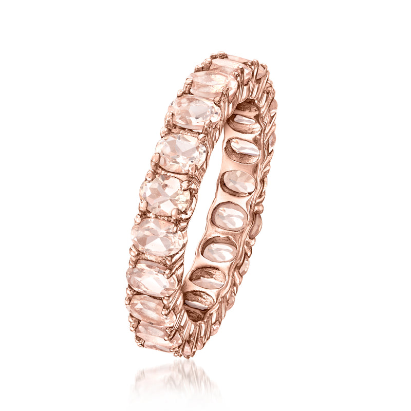 Rose-gold eternity band with raised pink oval-cut stones in repeating bezel settings