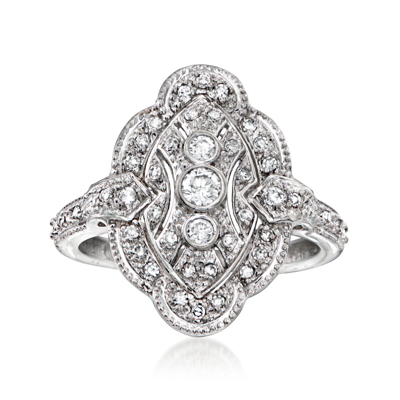 Vintage diamond ring in 14kt white gold with oval halo and round stone accents