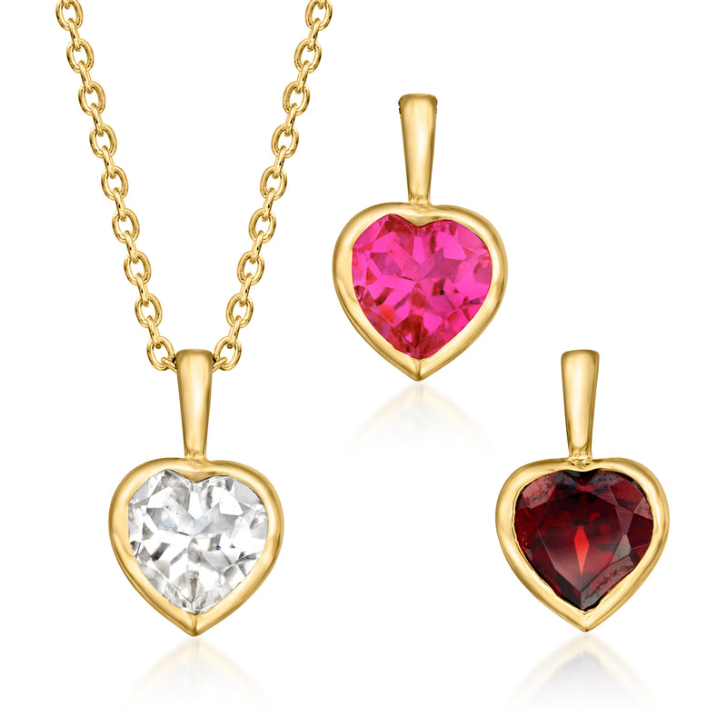 Gold cable-chain necklace with three heart pendants: clear, pink, and red gemstones