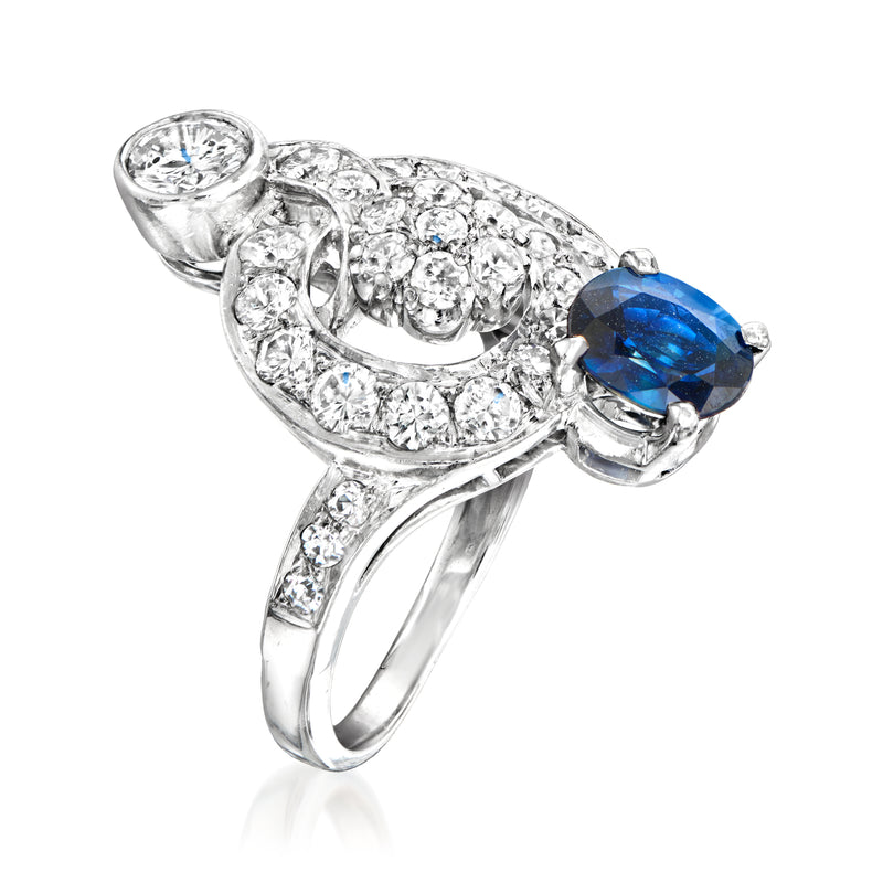 Diamond swirl ring with oval blue sapphire and silver-toned prong setting