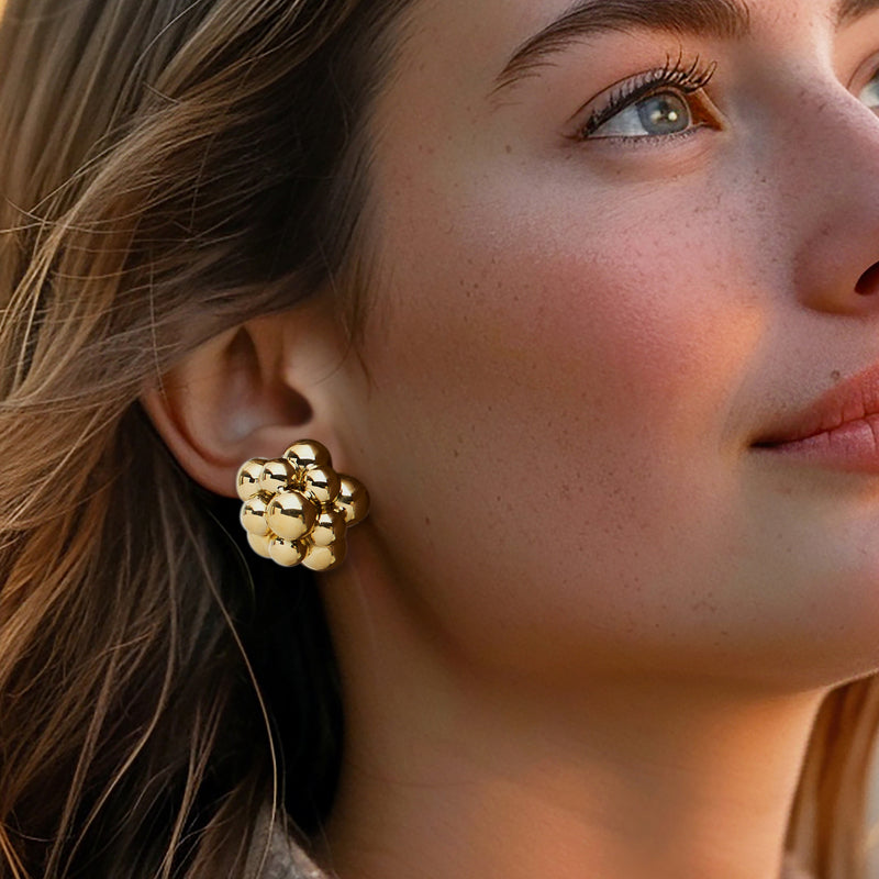 Gold circle cluster stud earrings on model, round ball flower design