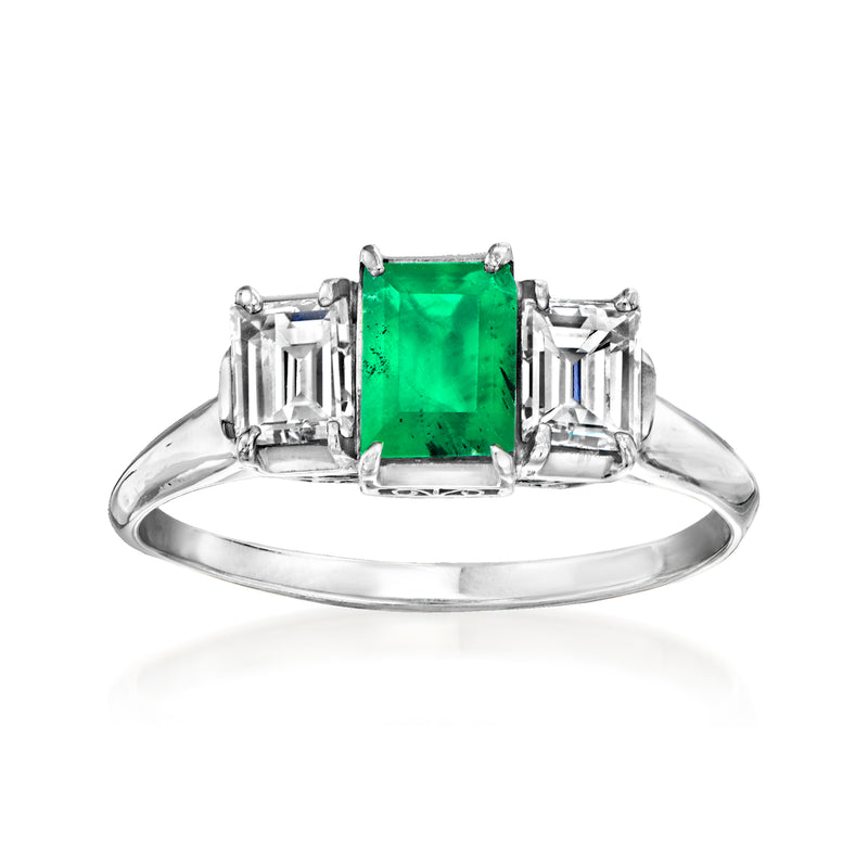 Vintage platinum ring with emerald-cut green gemstone and square step-cut side diamonds
