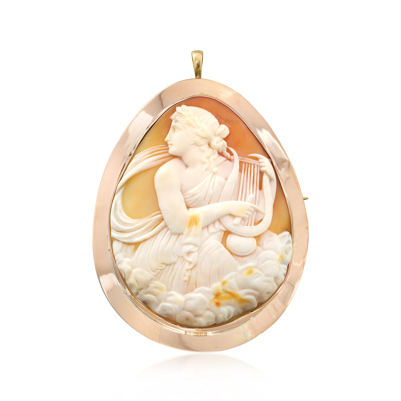 Vintage orange shell cameo pendant in 9kt gold, oval bezel with cherub figure.