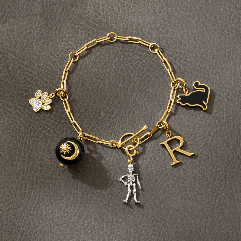 Gold charm bracelet featuring a paw print diamond charm and letter R charm