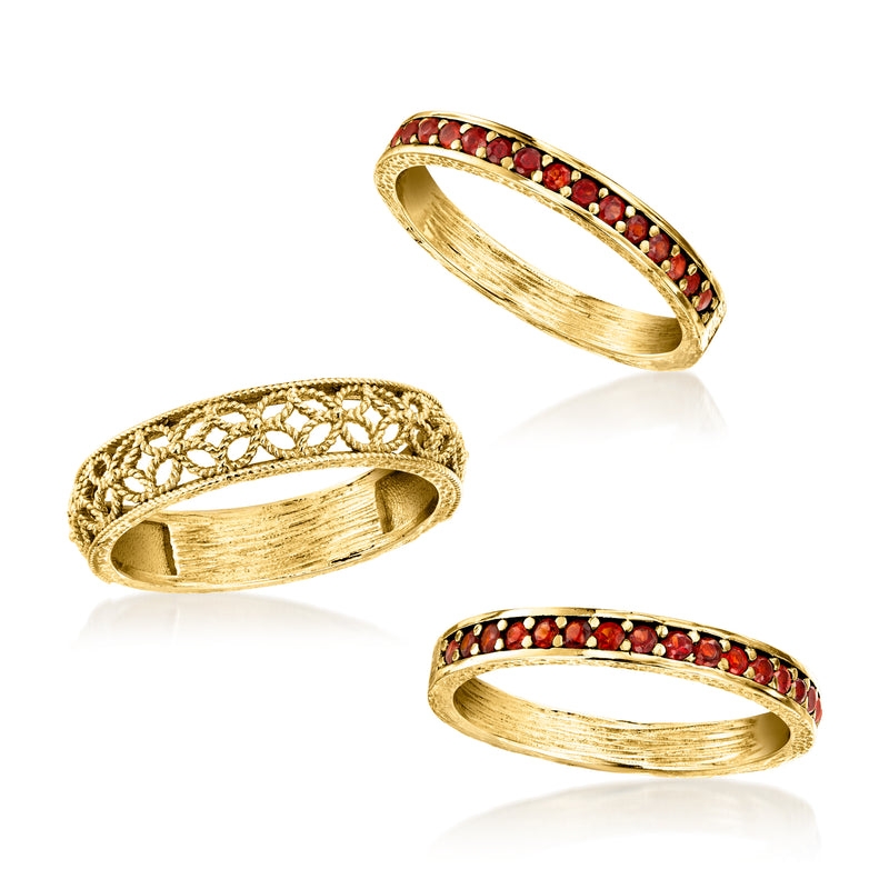 Three gold-tone rings angled display with red garnet stone band and filigree band
