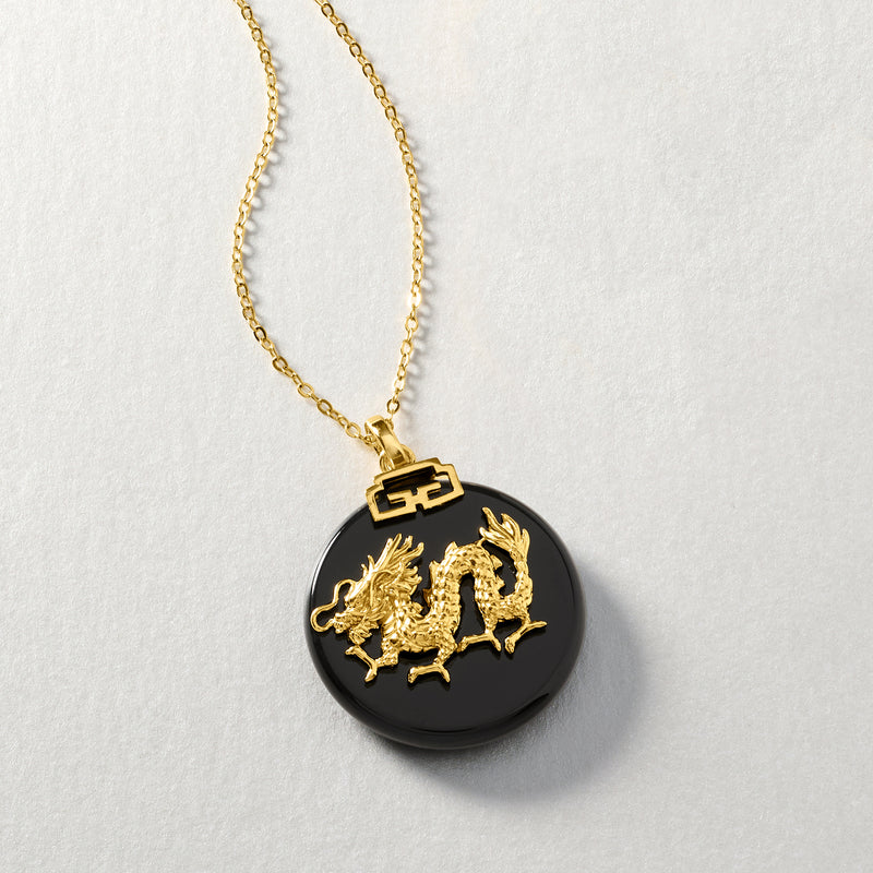Gold-tone pendant necklace with black round agate disc and gold zodiac dragon charm