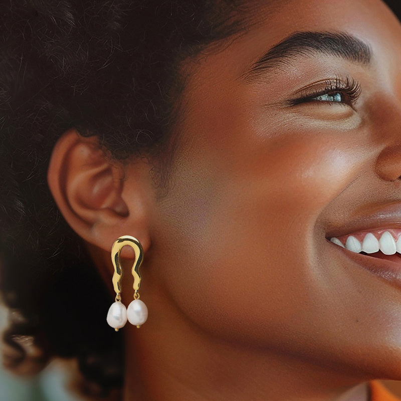 Gold wavy drop earrings with two white cultured pearls and curved hook tops
