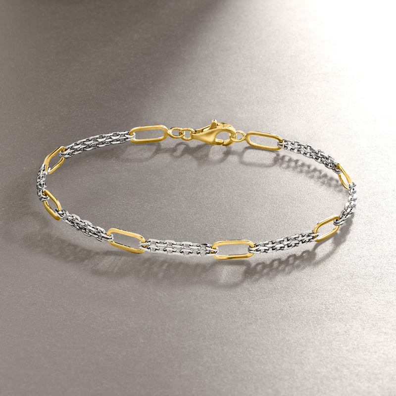 Silver link bracelet with gold center links and toggle clasp, side view