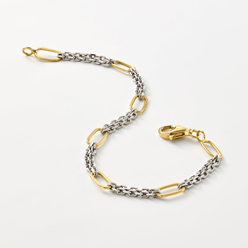 Paperclip-style chain bracelet with gold oval links on silver, angled view