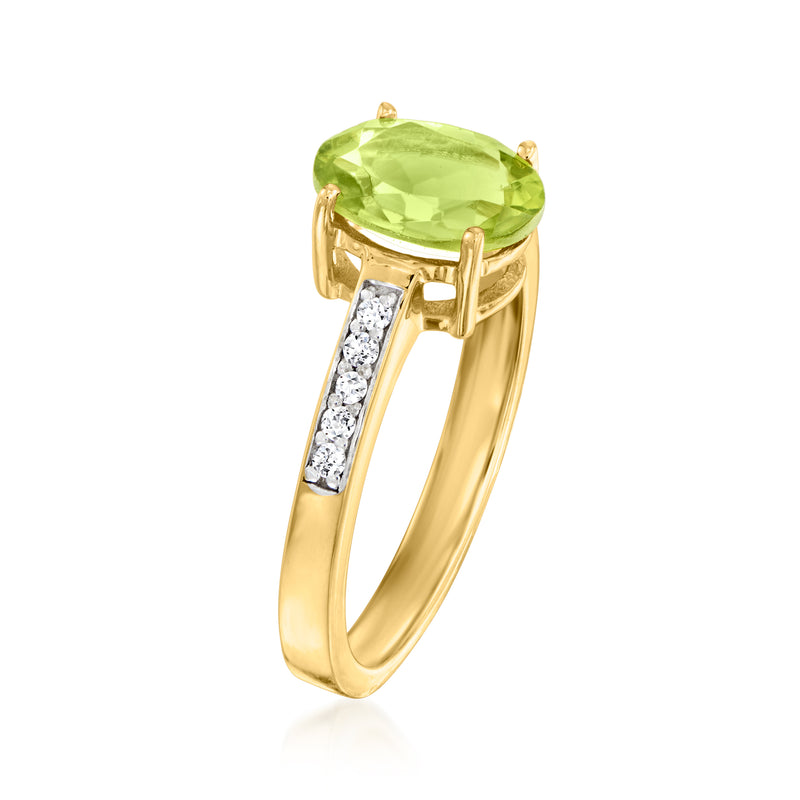 Gold ring with oval peridot in prong setting and diamond bar details