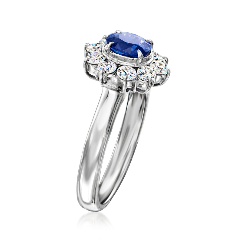 Platinum ring with oval blue sapphire and diamond cluster setting, side view