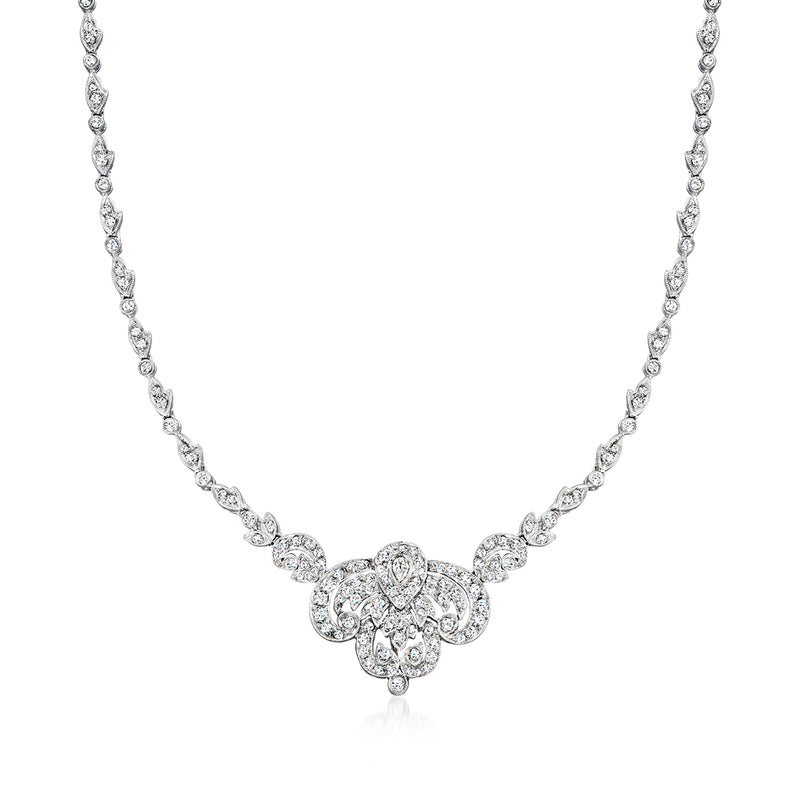 Vintage platinum diamond necklace with flower-shaped center cluster and linked stones