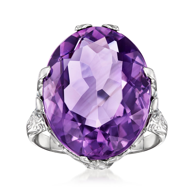 Amethyst oval gemstone ring in white gold with ornate bezel and prong setting.