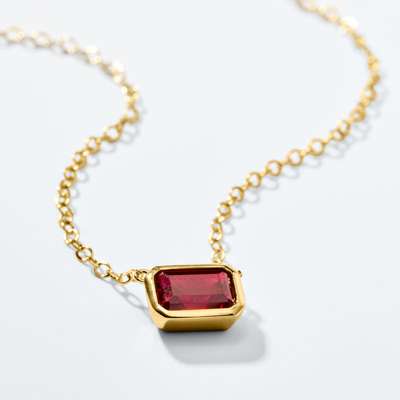 Gold ruby pendant necklace with red square-cut gemstone on link chain