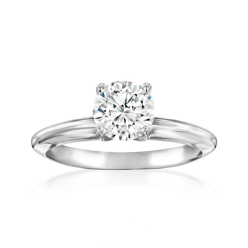 White gold solitaire diamond ring with four-prong center stone and polished band.