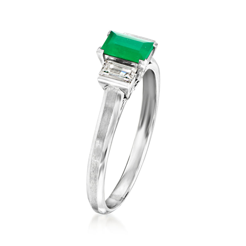 Platinum ring with emerald-cut green center stone and square baguette diamond shoulders