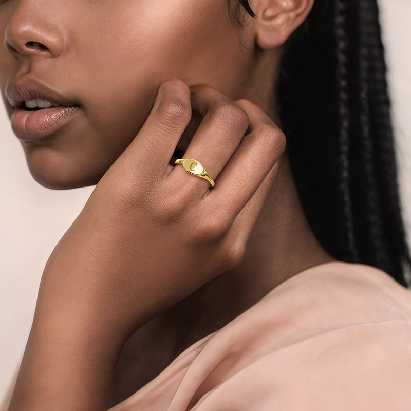 10kt yellow gold personalized signet ring on finger, oval top bezel