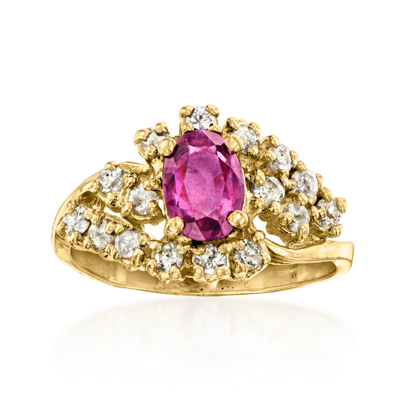 Oval purple-red gemstone ring in 14kt yellow gold with diamond cluster shoulders