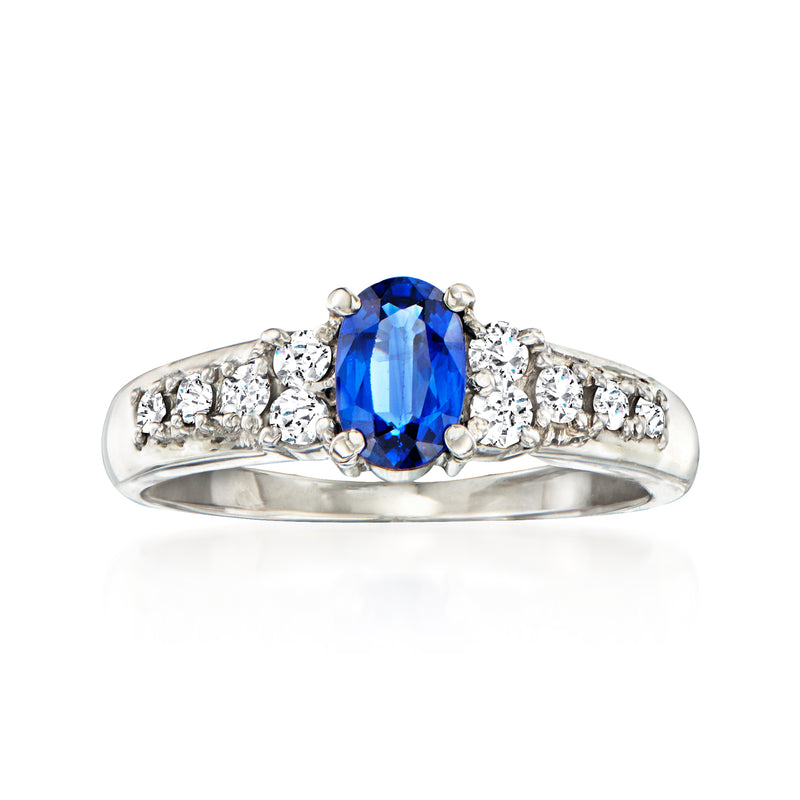 Platinum ring with oval blue sapphire center and small round diamond side stones