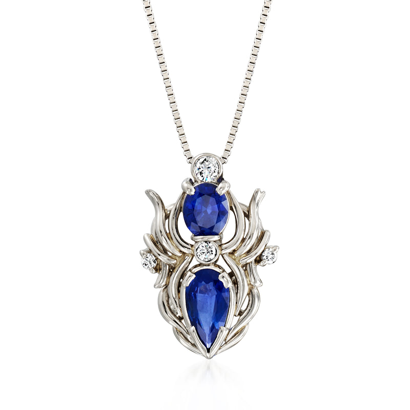 Platinum pendant necklace with blue sapphire center and diamond accents on a link chain
