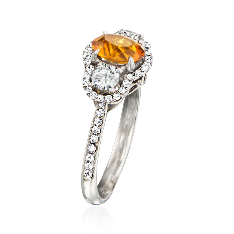 White gold ring with oval orange citrine top and round diamond accents, side view
