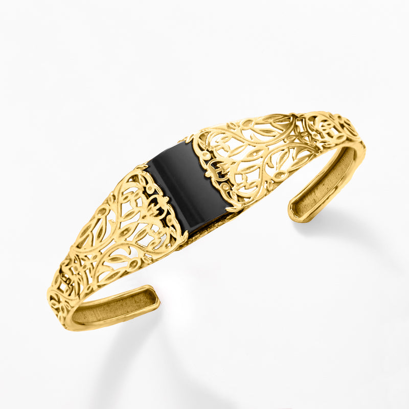 Gold filigree cuff bracelet with black onyx inlay, angled view