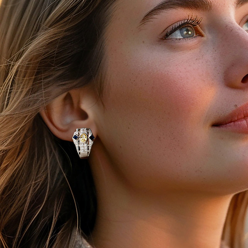 Close-up of yellow and blue sapphire small hoop-style post earrings with diamond accents