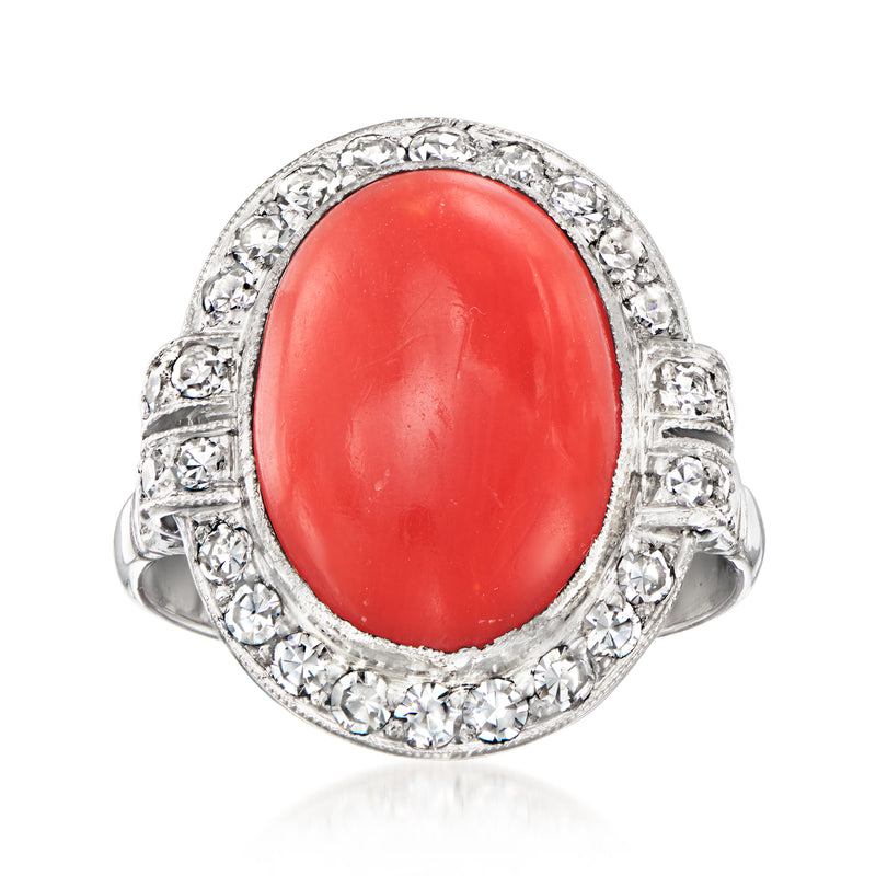 Vintage oval red coral ring with diamond halo and platinum band