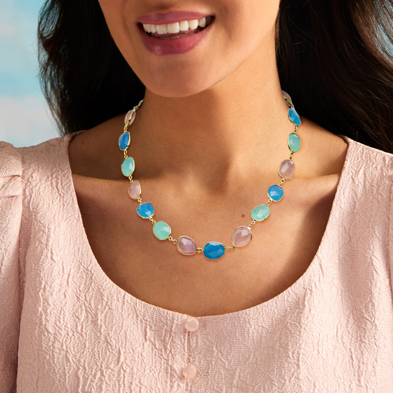 Gold-tone chalcedony station necklace with pastel pink, teal, and blue oval links.