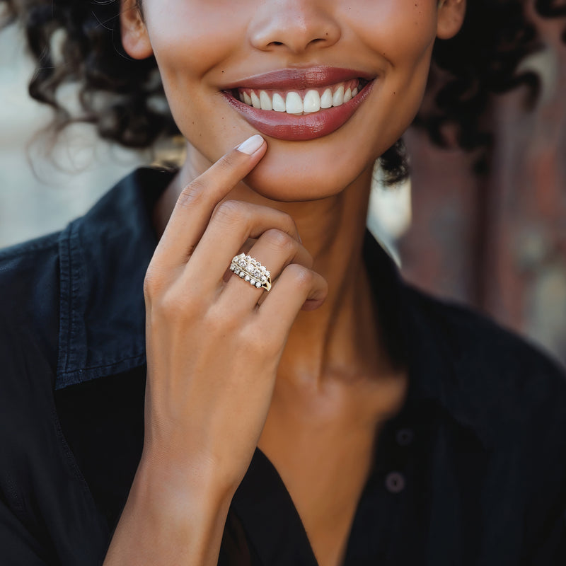 Three-row diamond ring on finger, 14k yellow gold band with round stones
