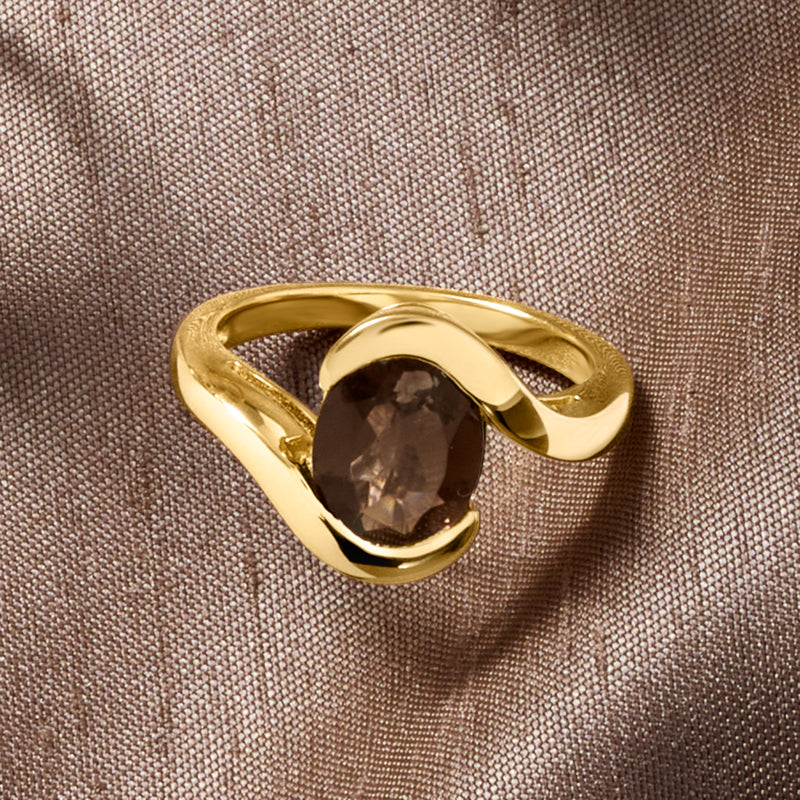 Gold swirl ring featuring oval smoky quartz cabochon, close-up on band details