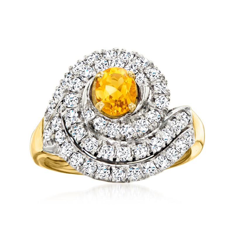 Vintage yellow gold ring with oval citrine center and diamond swirl halo