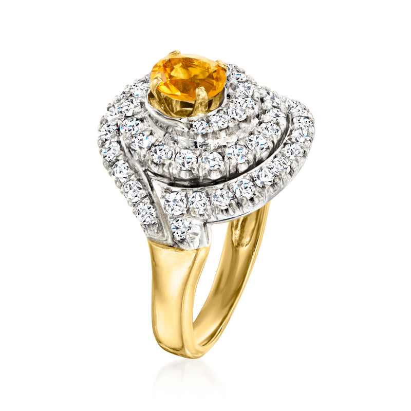 Yellow gold swirl ring with oval yellow citrine prong-set center and diamonds