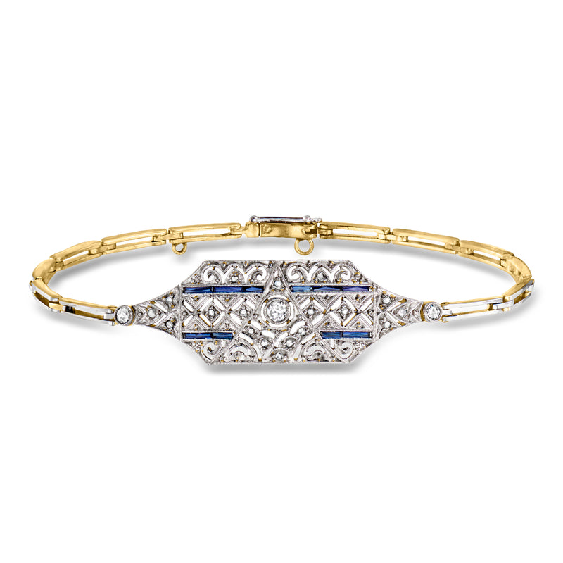 Filigree bracelet with blue gemstone panel and clear stones on gold-tone link band