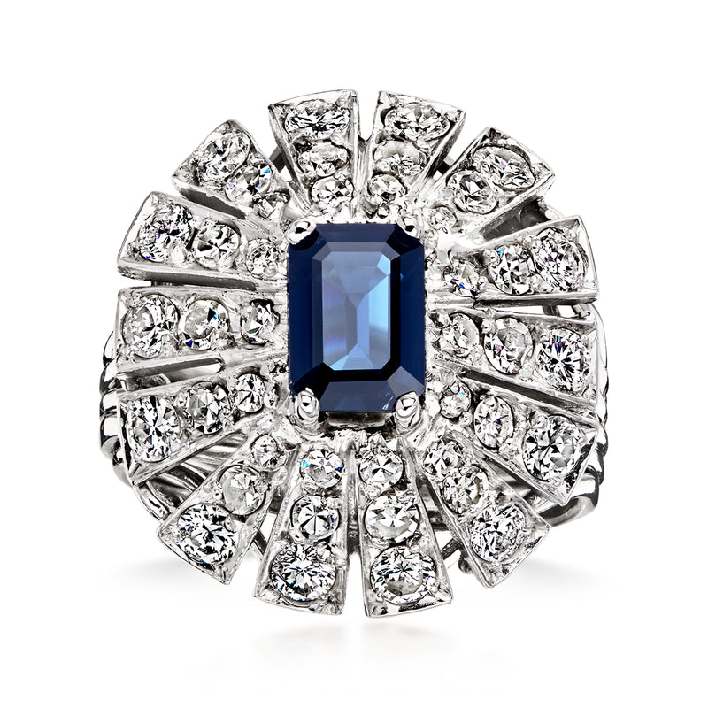 Platinum vintage ring with blue sapphire center and oval-cut diamond halo