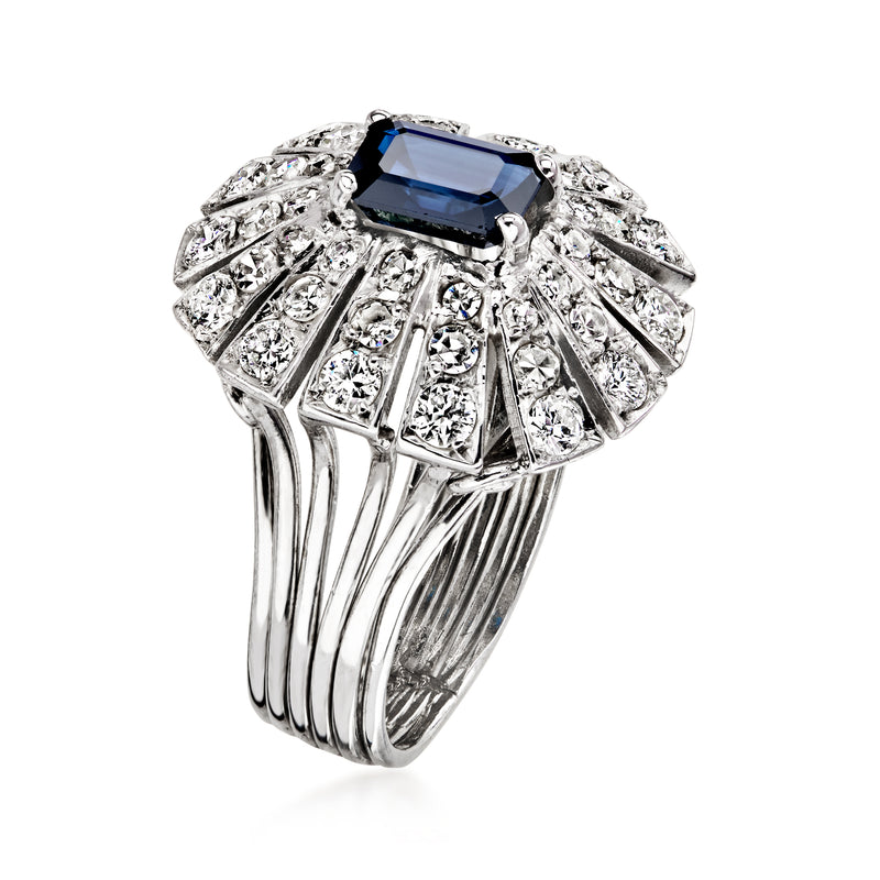 Platinum ring with dark blue rectangular sapphire and prong-set diamond accents