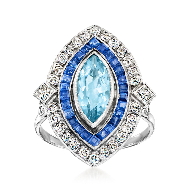 Vintage platinum ring with oval aquamarine center, blue sapphires, diamond halo