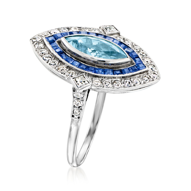 Platinum marquise ring with oval aquamarine, blue sapphire border, diamond accents