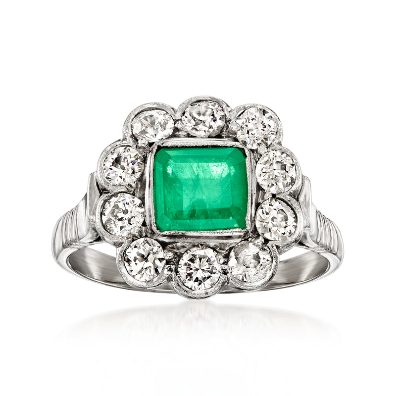Platinum vintage ring with green emerald-cut center and round diamond halo