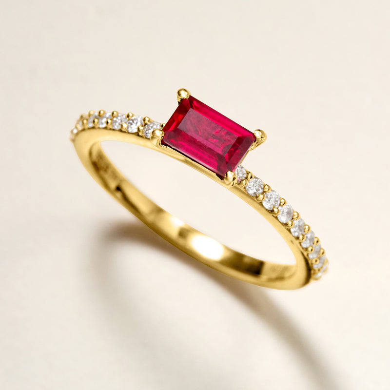 Gold ring angled view with red square ruby center and diamond halo