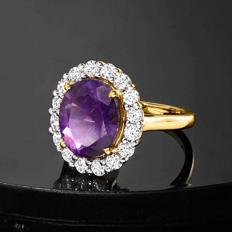 Gold amethyst ring with oval purple stone and round diamond halo, side view